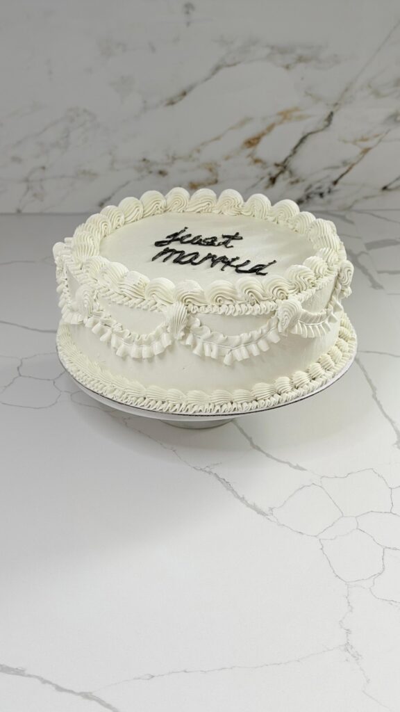 Just married round cake with vintage piping and script lettering