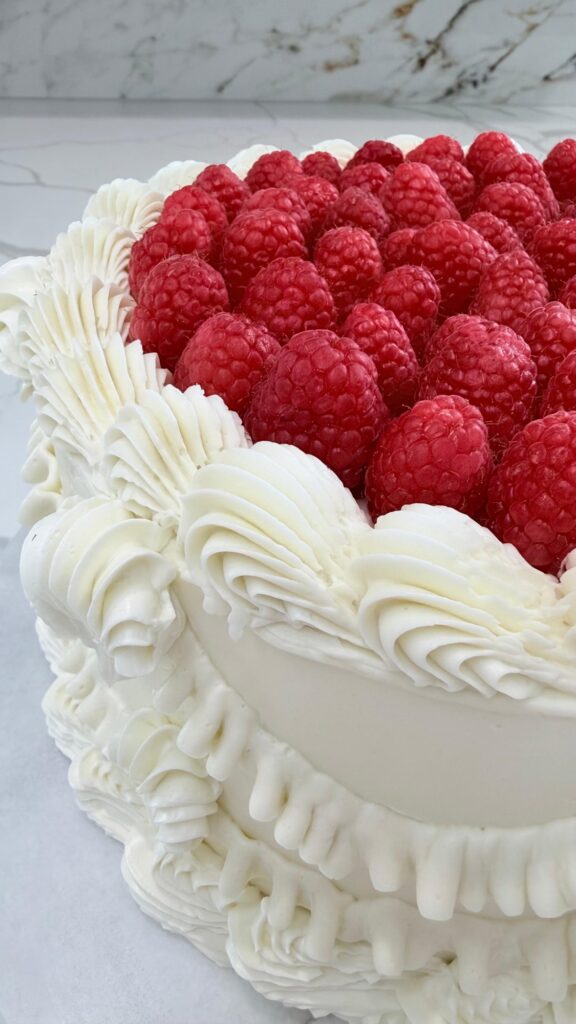Close-up of raspberries and piped buttercream detail